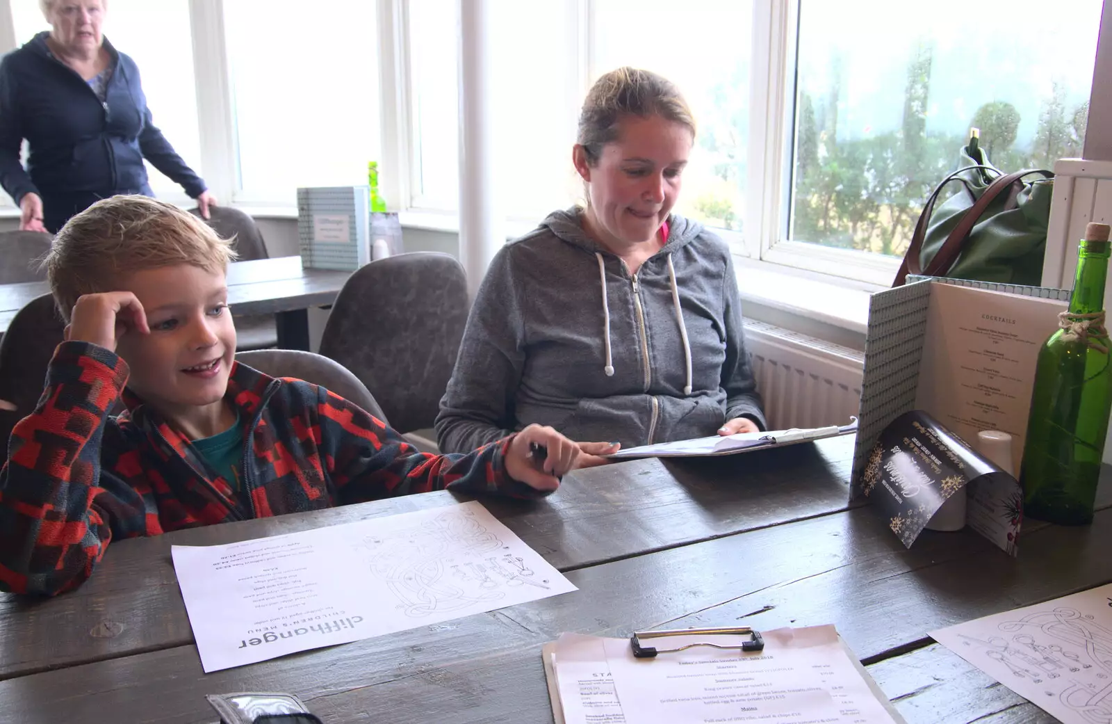 Harry and Isobel scope out the menu in Cliffhanger, from Blustery Beach Trips, Walkford and Highcliffe, Dorset - 29th July 2018