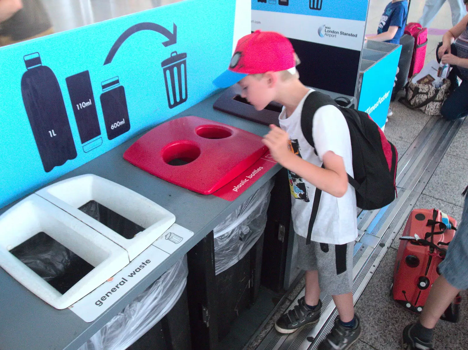 Harry peers into the liquid bottle bins, from A Trip to Da Gorls, Monkstown Farm, County Dublin, Ireland - 4th August 2018