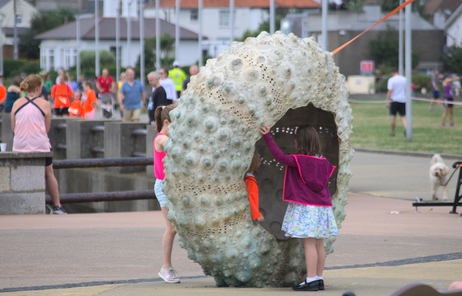 Children play in a giant sea-urchin sculpture from The Dún Laoghaire 10k Run, County Dublin, Ireland - 6th August 2018