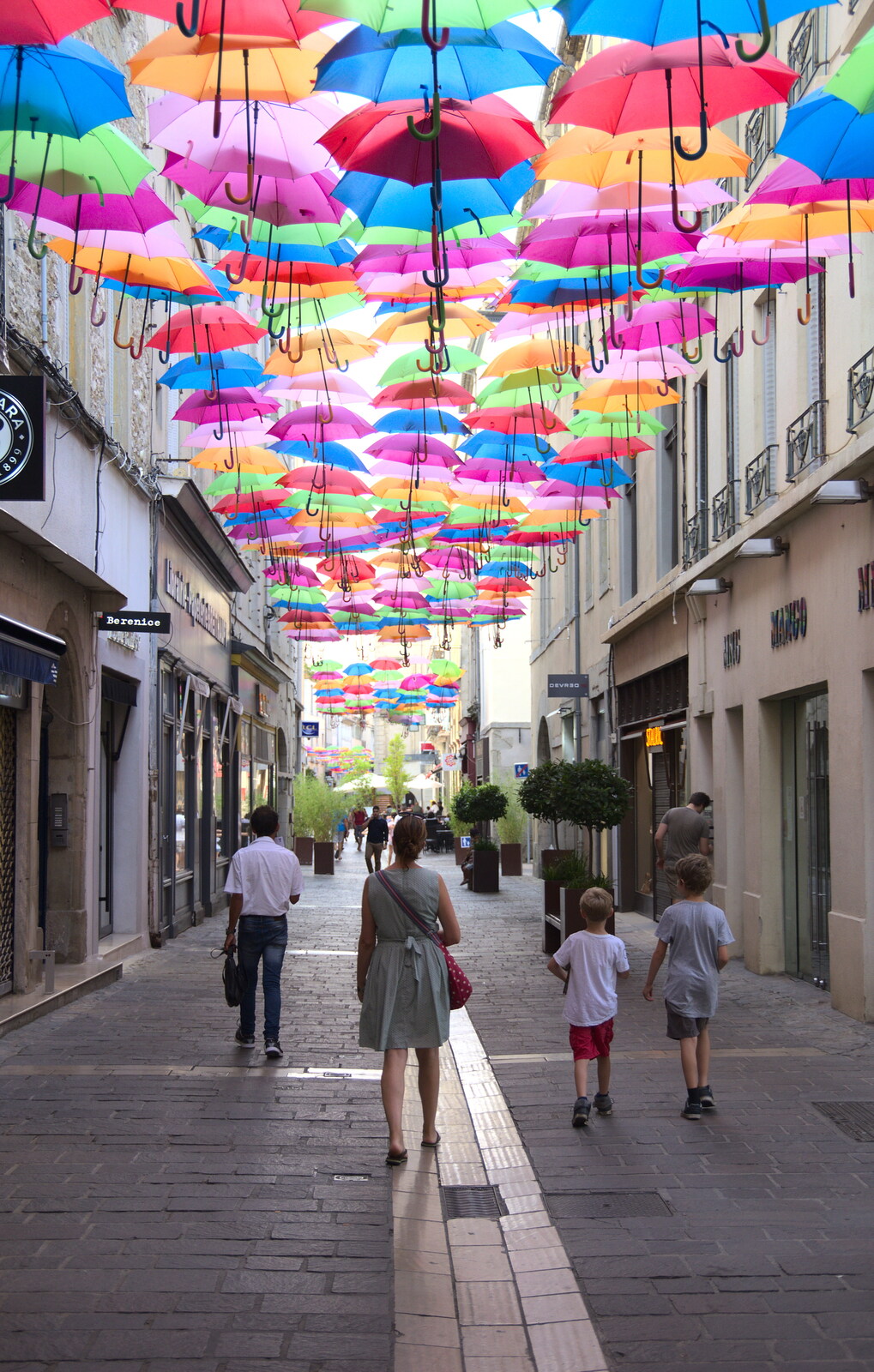 Isobel, Harry and Fred wander under the parapluies from A Trip to Carcassonne, Aude, France - 8th August 2018