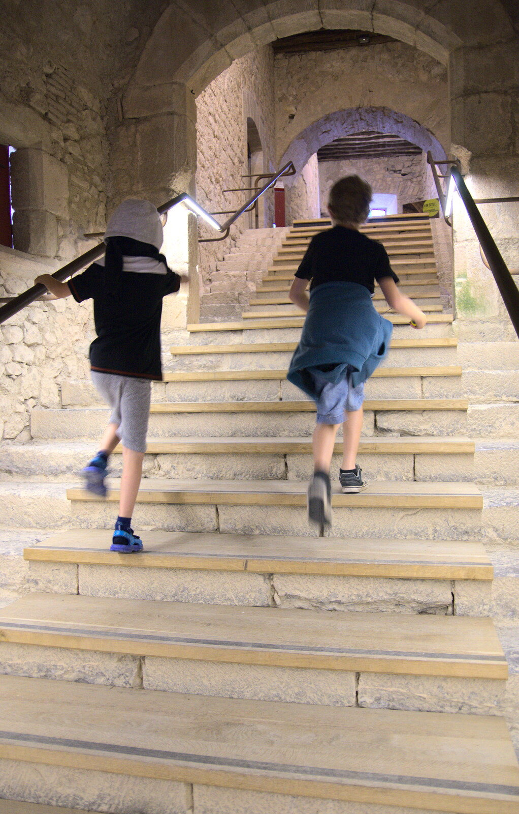 The boys run up some steps from Abbaye Sainte-Marie de Lagrasse and The Lac de la Cavayère, Aude, France - 10th August