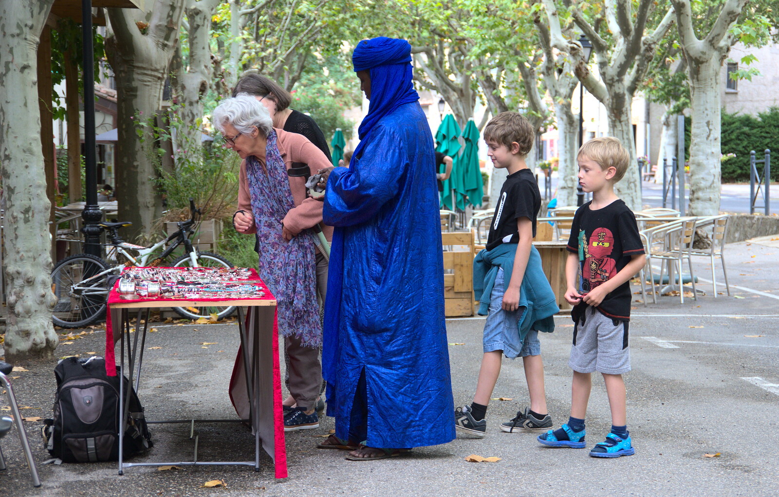 A dude in spectacularly-blue robes sells jewellry from Abbaye Sainte-Marie de Lagrasse and The Lac de la Cavayère, Aude, France - 10th August