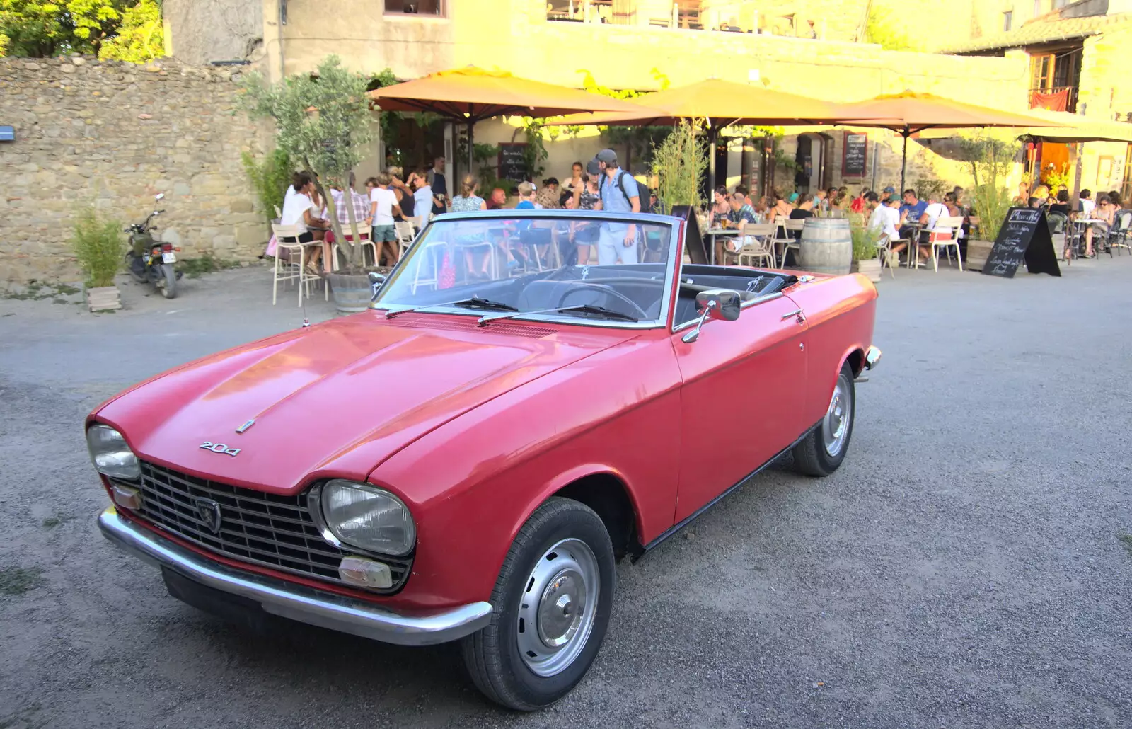 There's a Peugeot 204 convertible in the square, from Abbaye Sainte-Marie de Lagrasse and The Lac de la Cavayère, Aude, France - 10th August