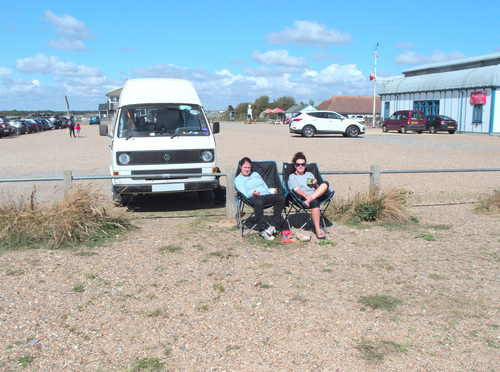 Isobel and Evelyn drink tea in front of the van from A Day on the Beach, Southwold, Suffolk - 25th August 2018