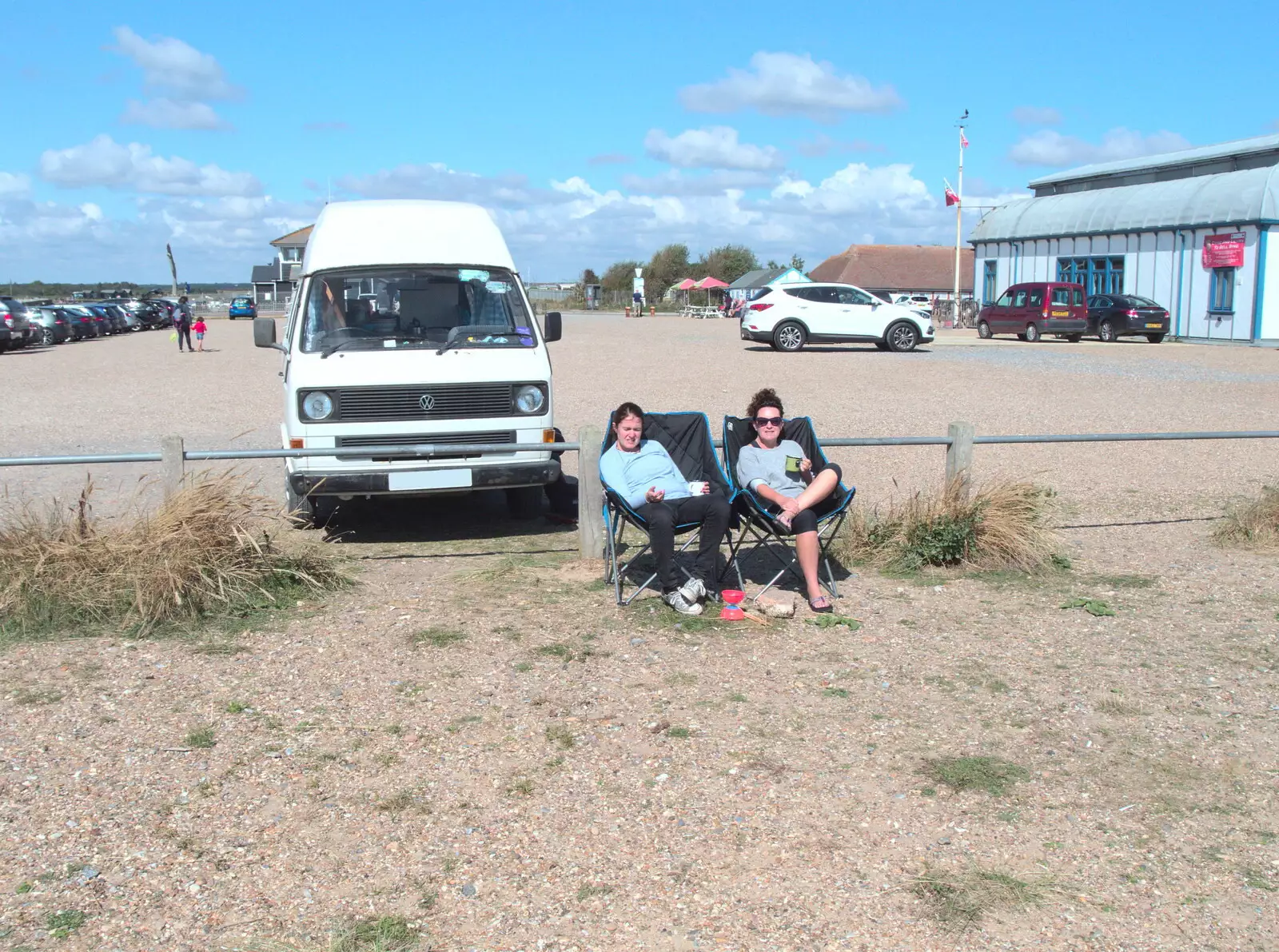 Isobel and Evelyn drink tea in front of the van, from A Day on the Beach, Southwold, Suffolk - 25th August 2018