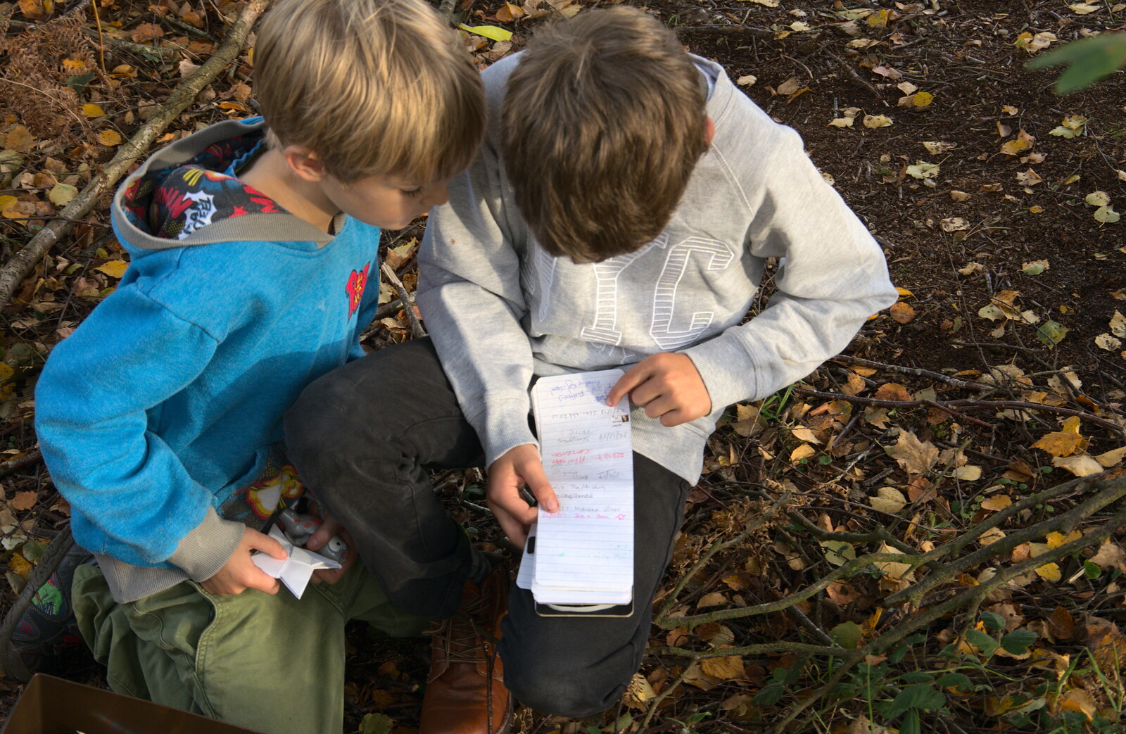 The boys read a listof messages from Evidence of Autumn: Geocaching on Knettishall Heath, Suffolk - 7th October 2018