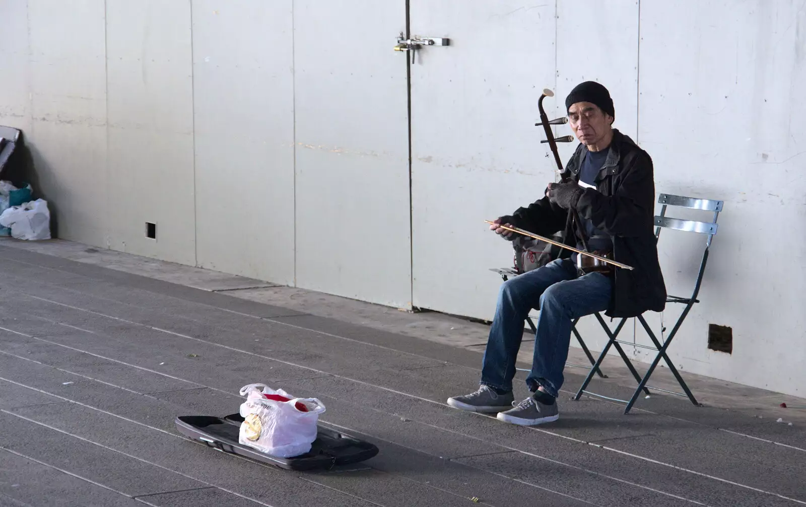 An Erhu player in a bleak concrete underpass, from Times Square, USS Intrepid and the High Line, Manhattan, New York - 25th October 2018