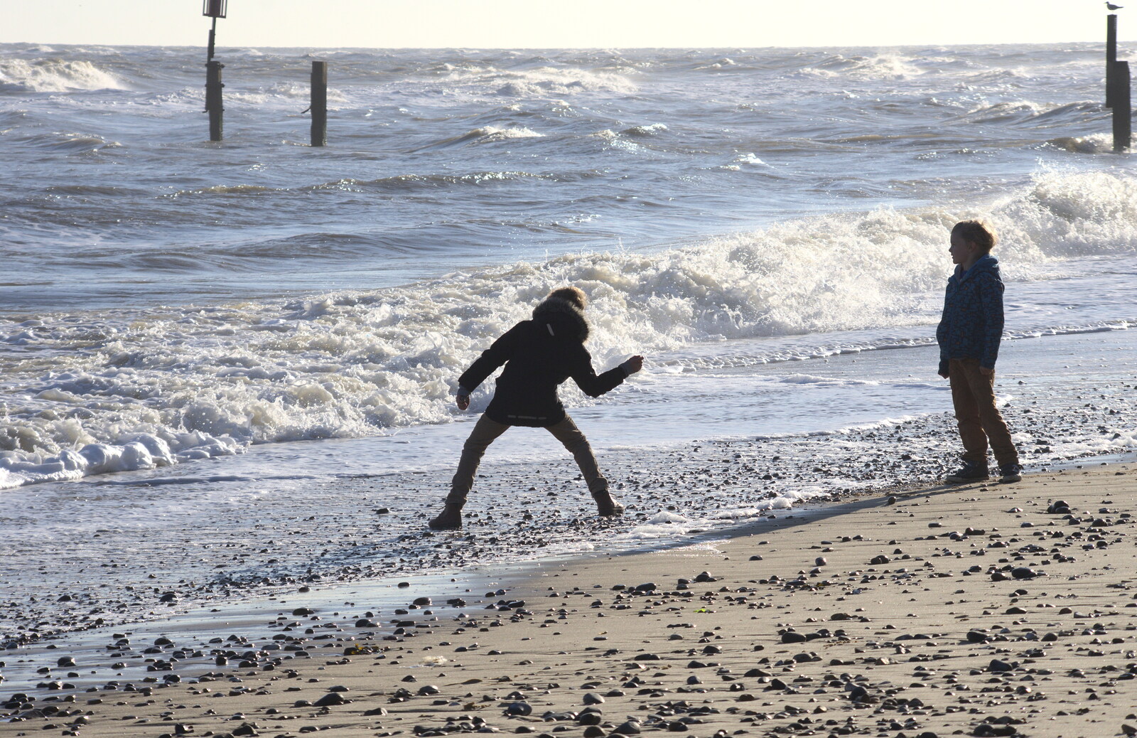 Fred hurls a stone into the sea from Sunset at the Beach, Southwold, Suffolk - 18th November 2018