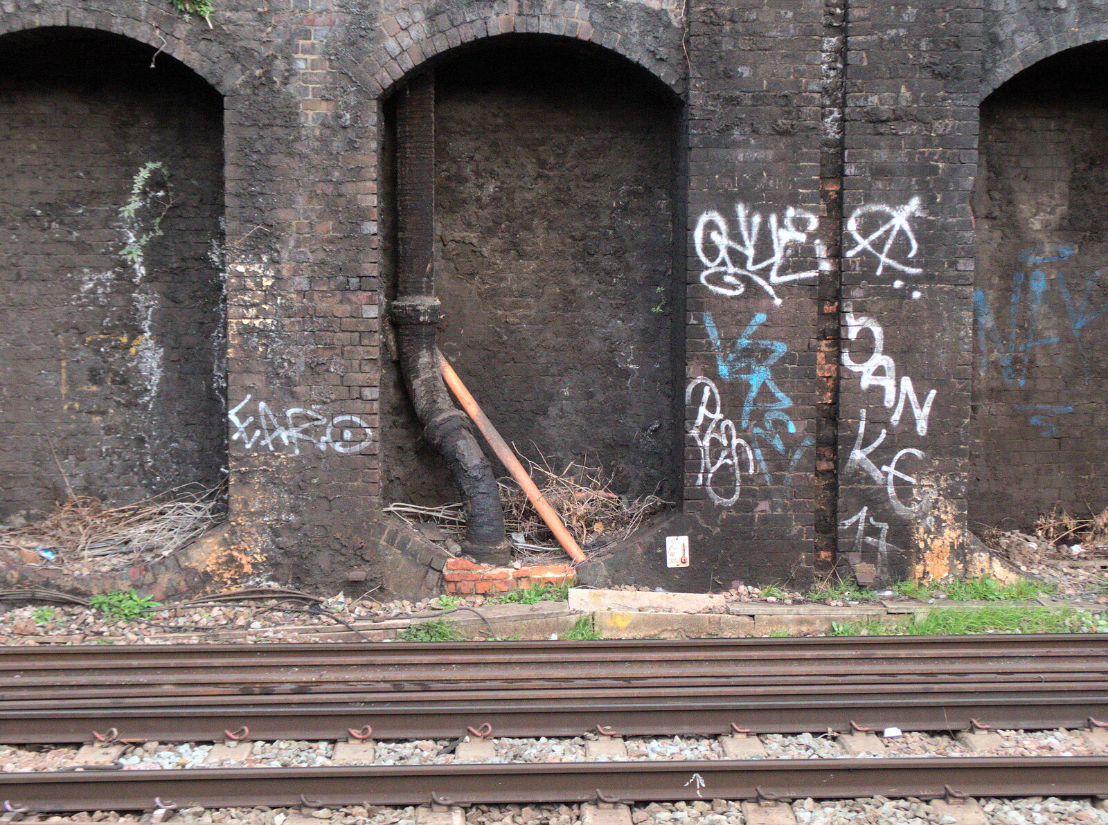 A pipe comes and goes through a brick arch from Railway Graffiti, Tower Hamlets, London - 12th February 2019