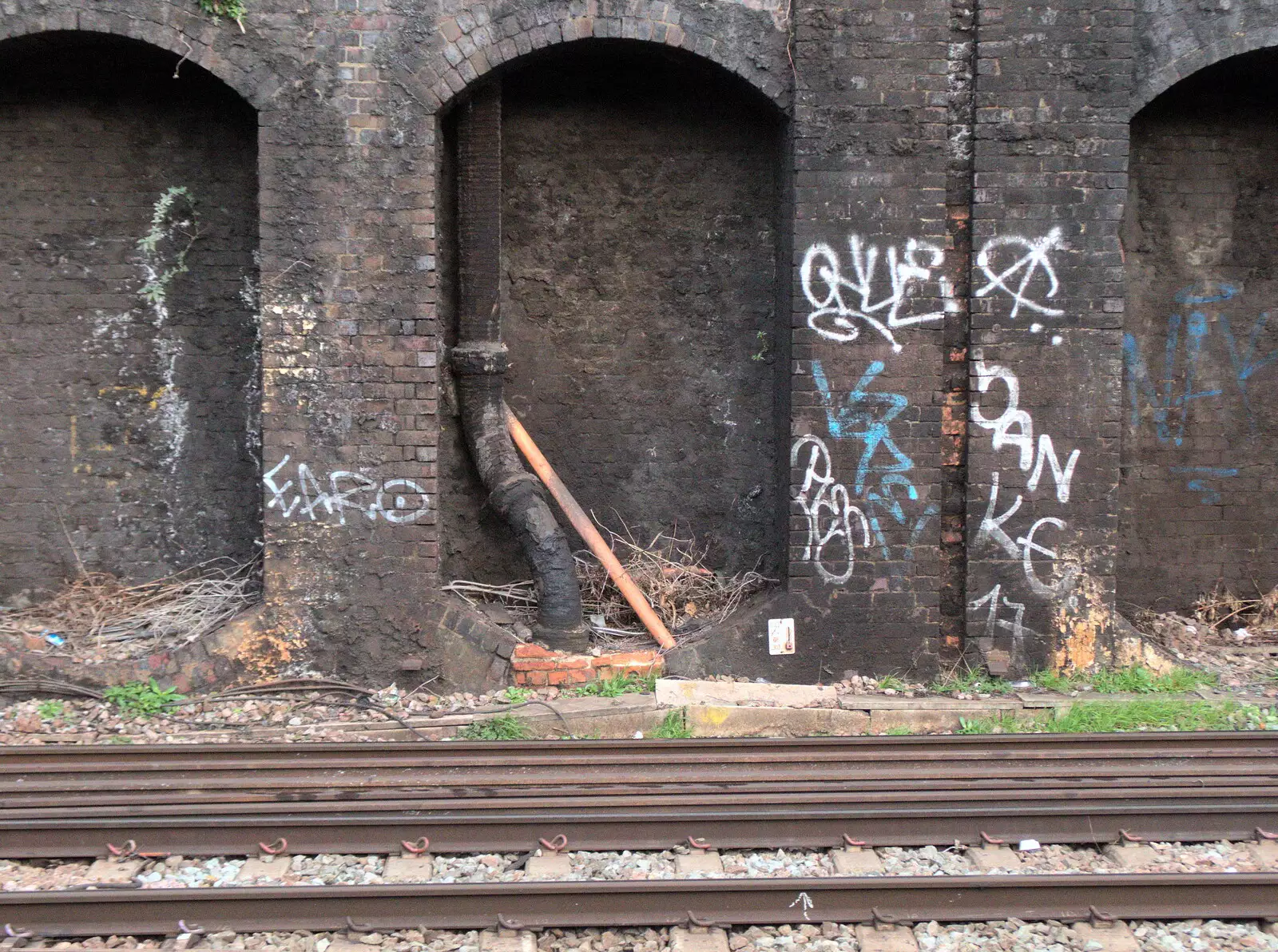 A pipe comes and goes through a brick arch, from Railway Graffiti, Tower Hamlets, London - 12th February 2019