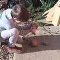 Fred smashes open a coconut with a rock, Diss Express Photos and a Garden Den, Eye, Suffolk - 23rd February 2019