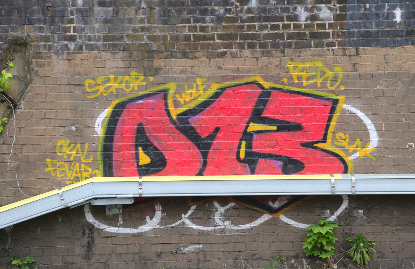 Signalling runs over graffiti on a wall from A Team Outing at Namco Funscape, South Bank, London - 27th March 2019