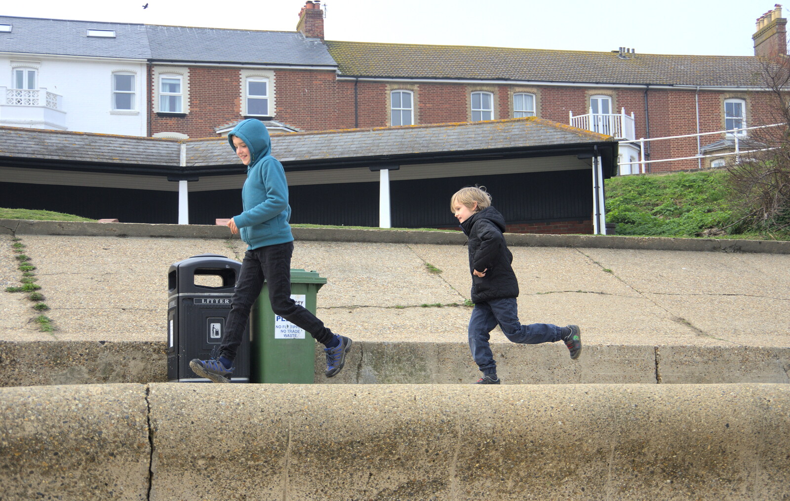 Fred and Harry run along the sea wall from On The Beach, Southwold, Suffolk - 7th April 2019