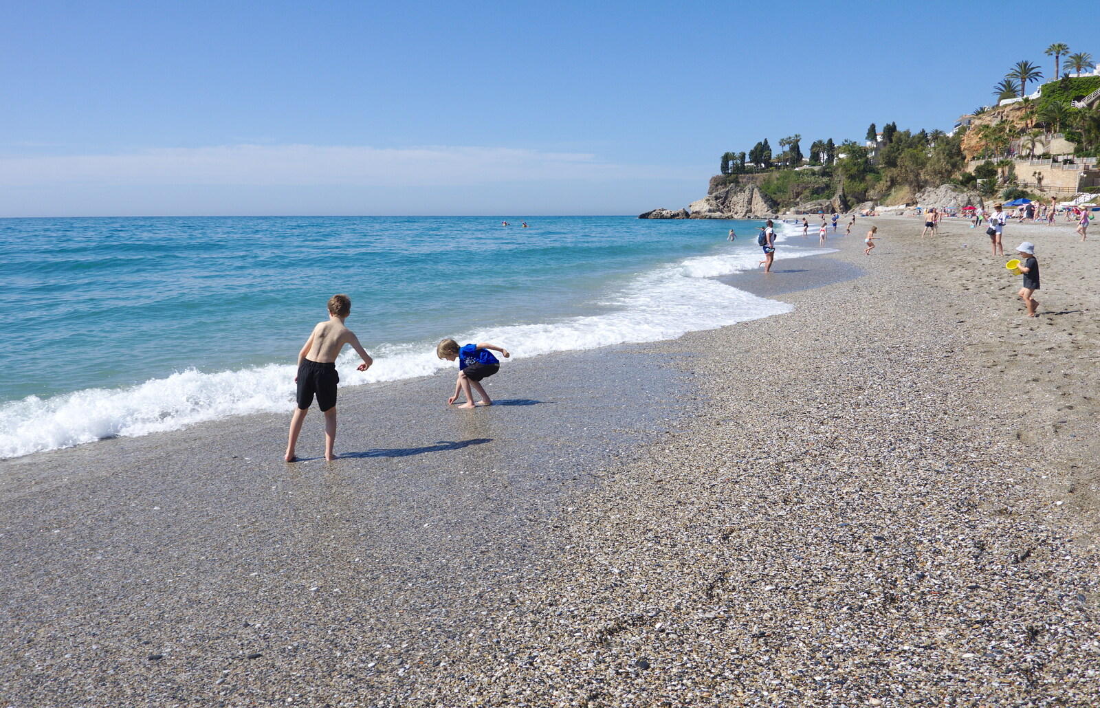 The boys hurl stones into the sea from A Holiday in Nerja, Andalusia, Spain - 15th April 2019