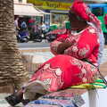 An African woman waits to sell blankets, Torrecilla Beach and the Nerja Museum, Andalusia, Spain - 17th April 2019