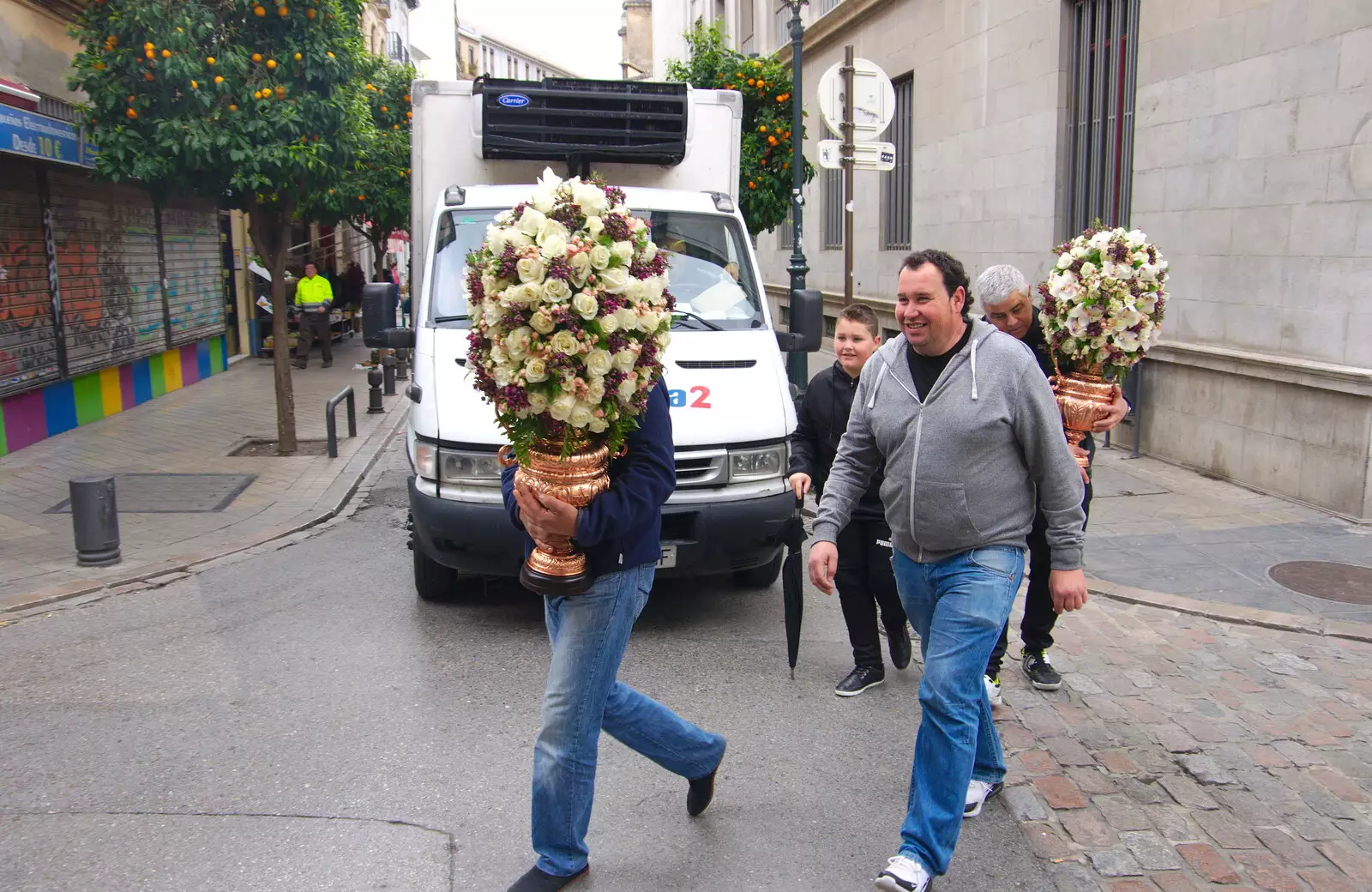 Some dudes rush past with big flower bushes in pots, from A Walk up a Hill, Paella on the Beach and Granada, Andalusia, Spain - 19th April 2018