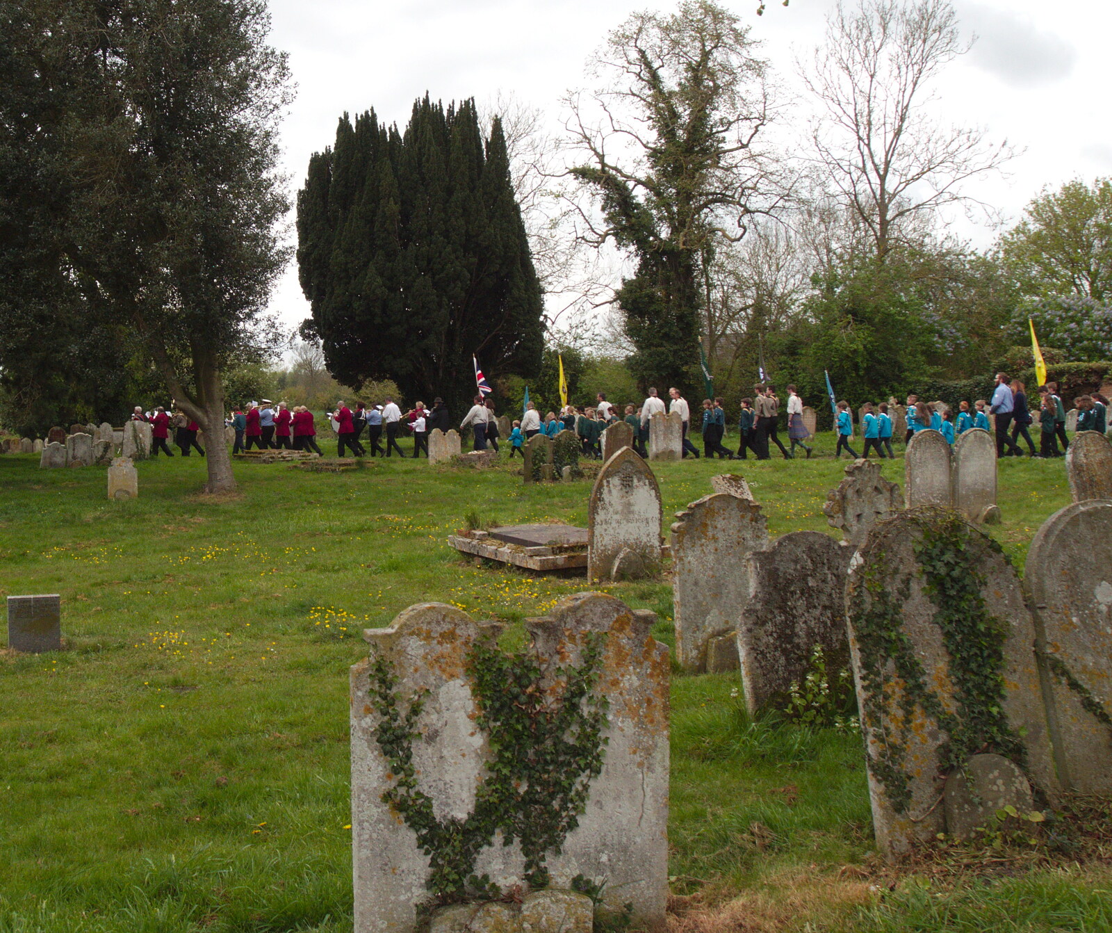 The procession passes through the graveyard from A St. George's Day Parade, Dickleburgh, Norfolk - 28th April 2019
