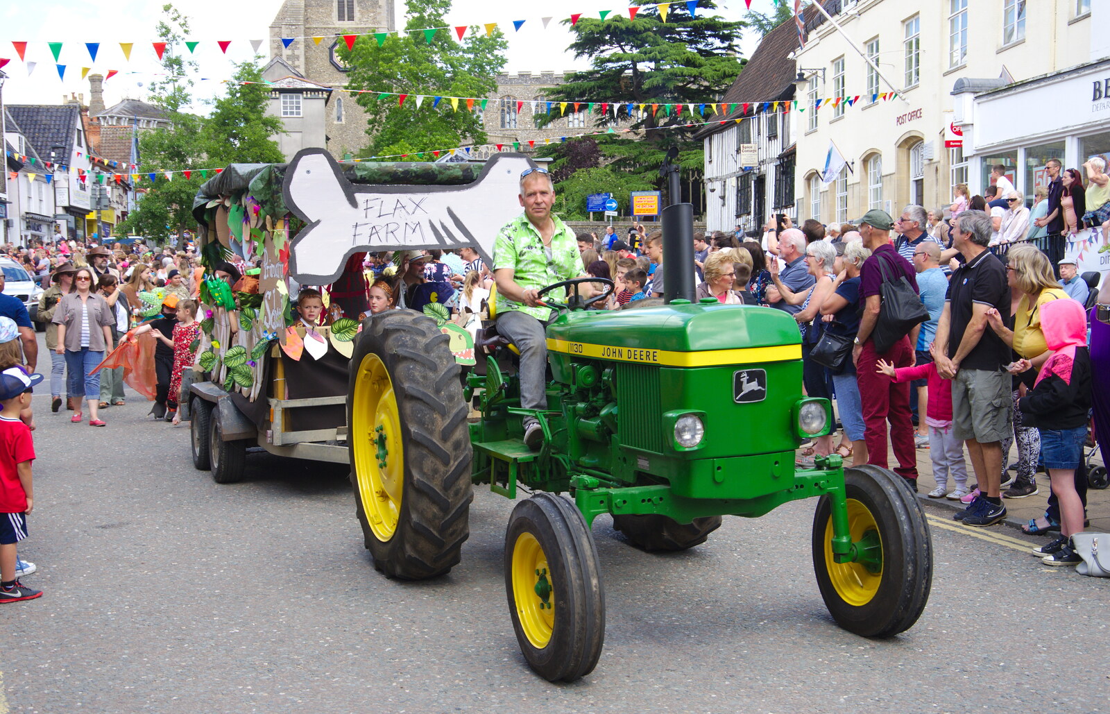 A John Deere tractor from Flax Farm trundles past from The Diss Carnival 2019, Diss, Norfolk - 9th June 2019