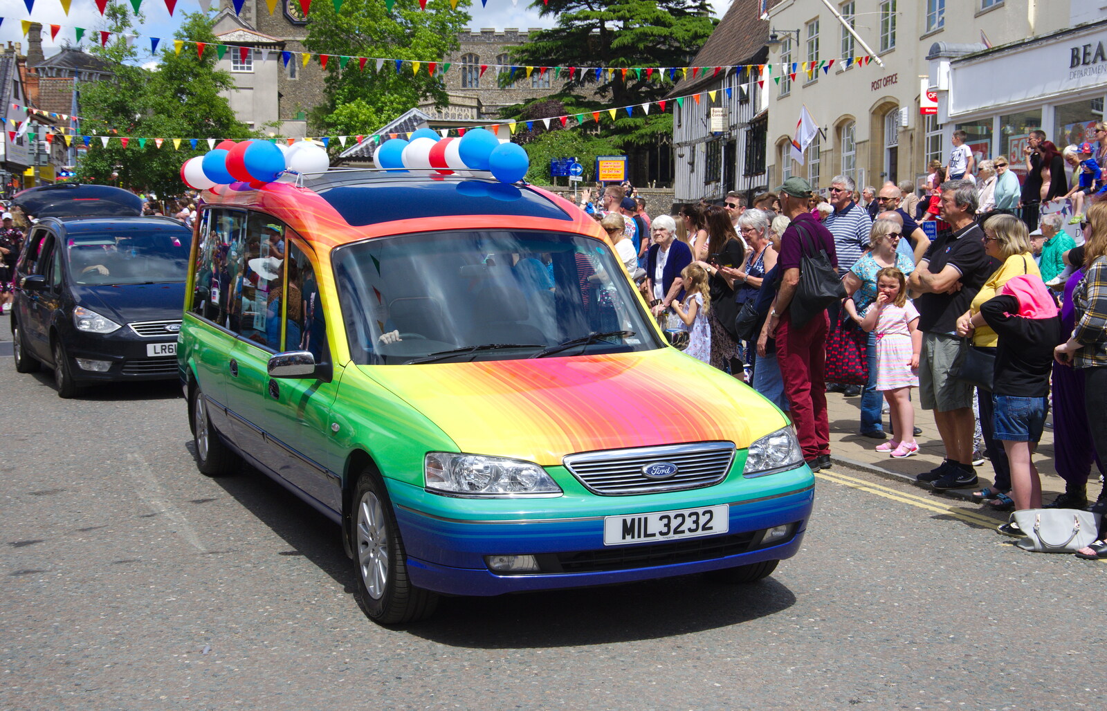 A funky rainbow-covered funeral car drives past from The Diss Carnival 2019, Diss, Norfolk - 9th June 2019
