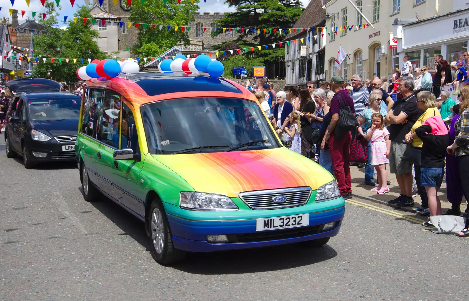 A funky rainbow-covered funeral car drives past, from The Diss Carnival 2019, Diss, Norfolk - 9th June 2019