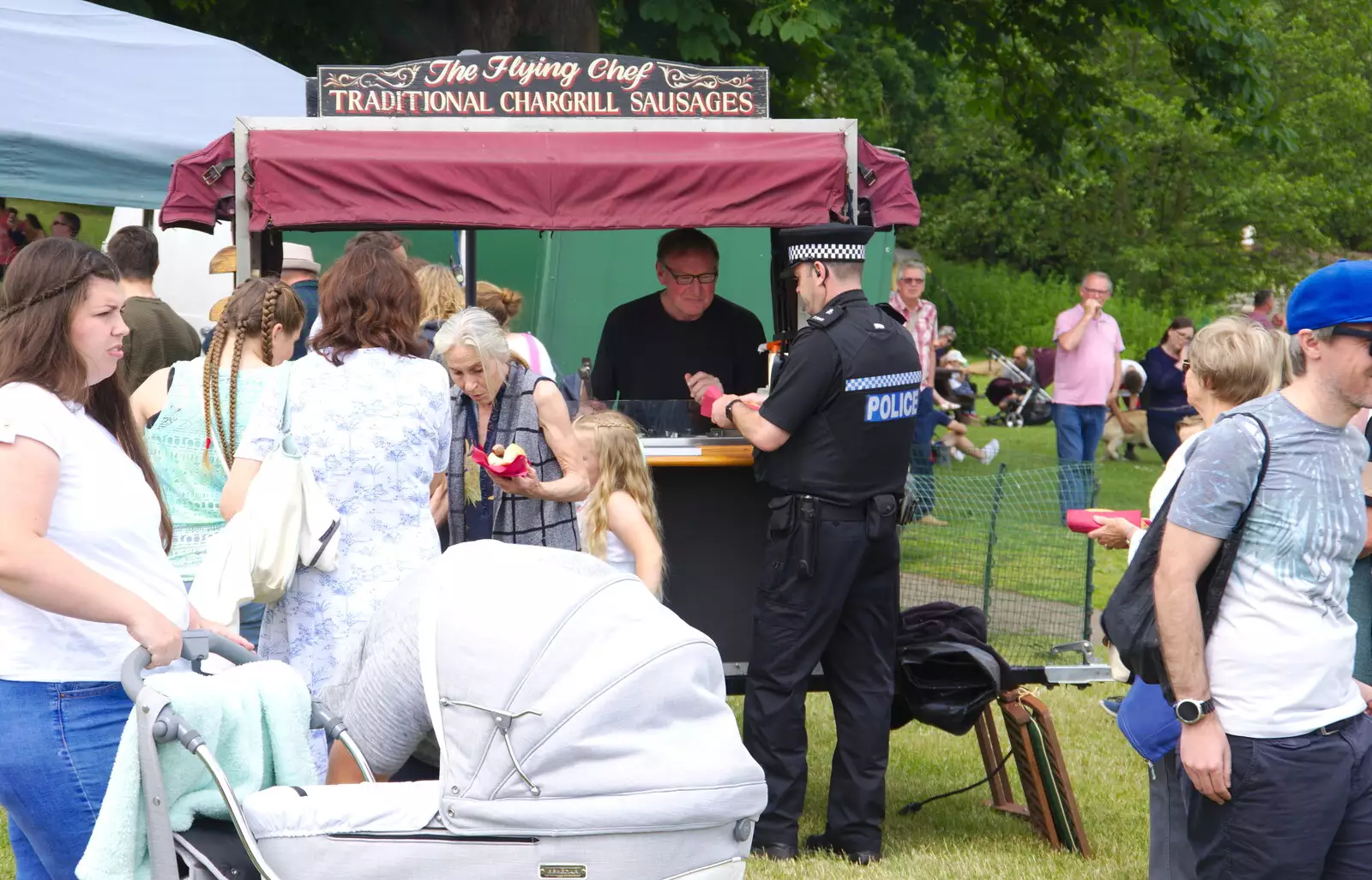 Andy Sausage serves a rozzer, from The Diss Carnival 2019, Diss, Norfolk - 9th June 2019