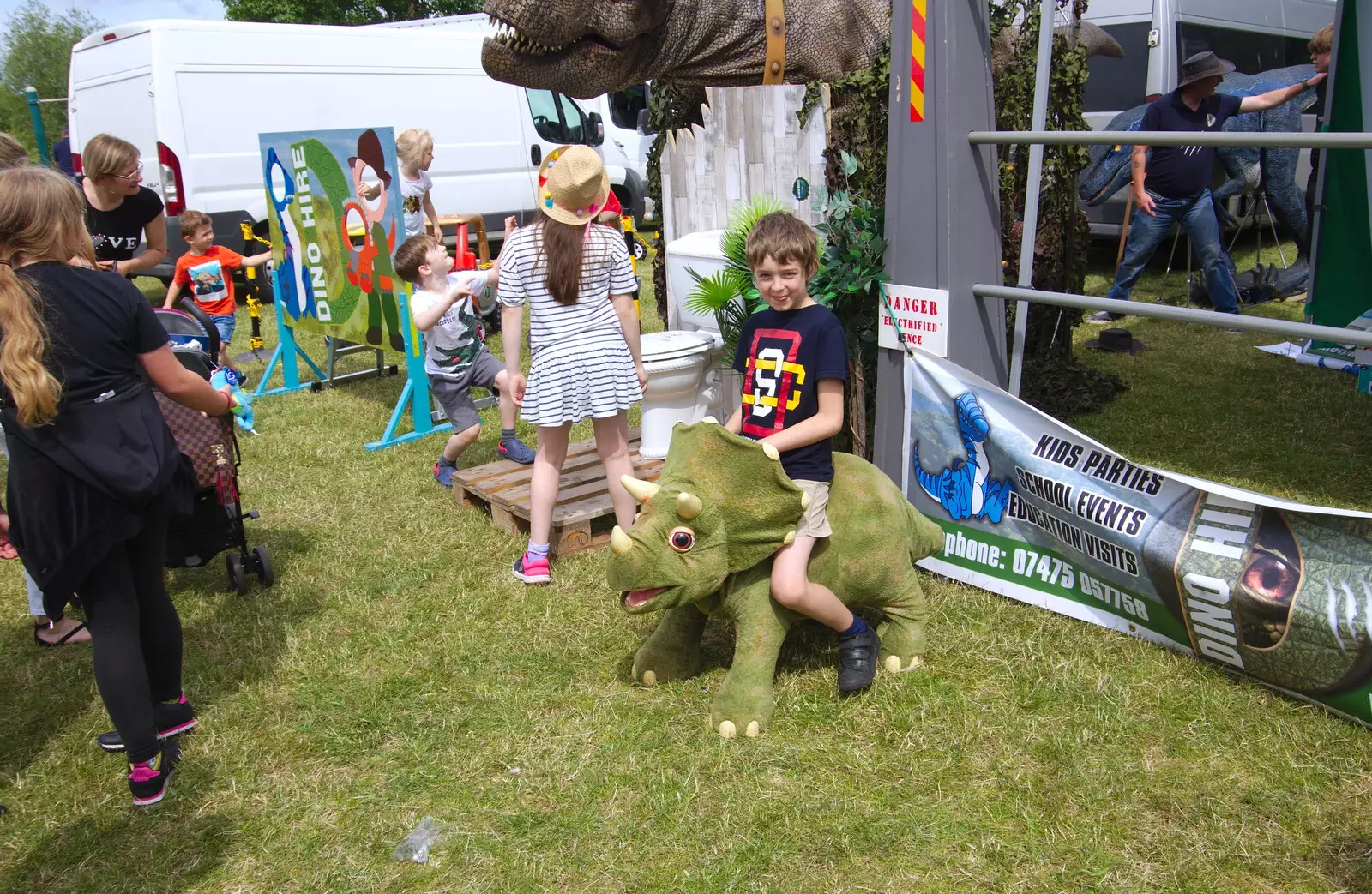 Fred rides a small triceratops, from The Diss Carnival 2019, Diss, Norfolk - 9th June 2019