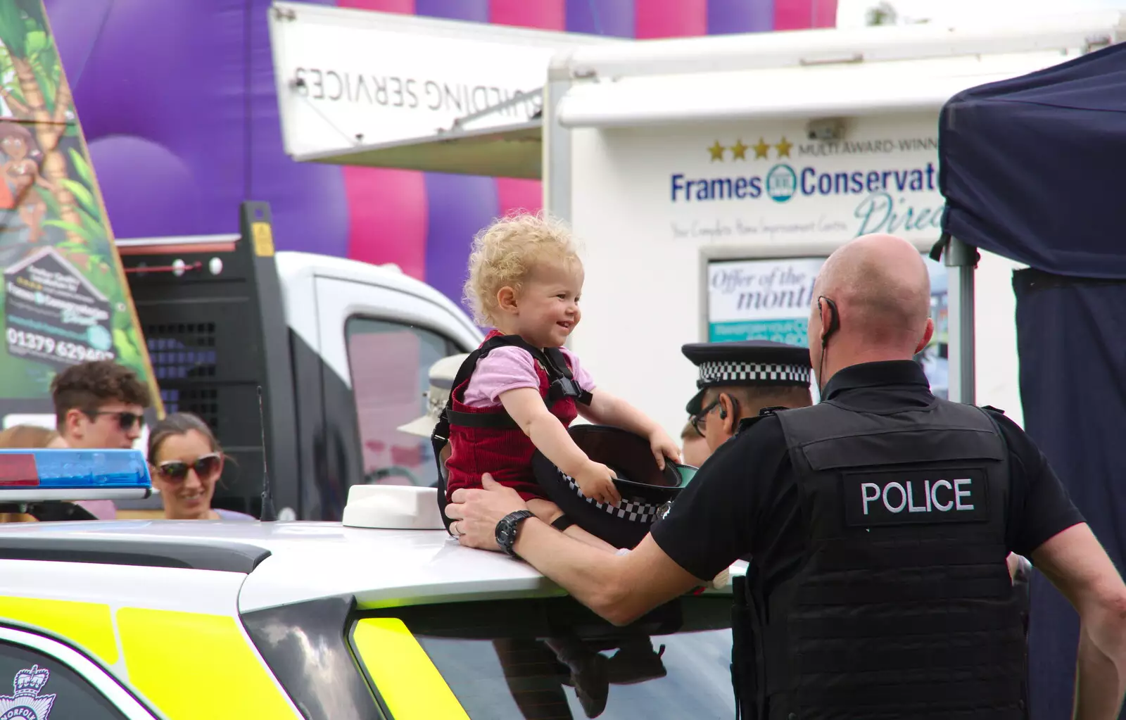 A small child tries on a rozzer's hat, from The Diss Carnival 2019, Diss, Norfolk - 9th June 2019