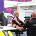 A small child tries on a rozzer's hat, The Diss Carnival 2019, Diss, Norfolk - 9th June 2019