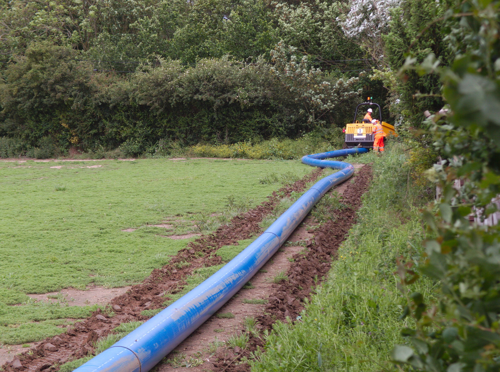 High-pressure water pipe is laid on the field from A High-Pressure Watermain and some Graffiti, Eye and London - 11th June 2019