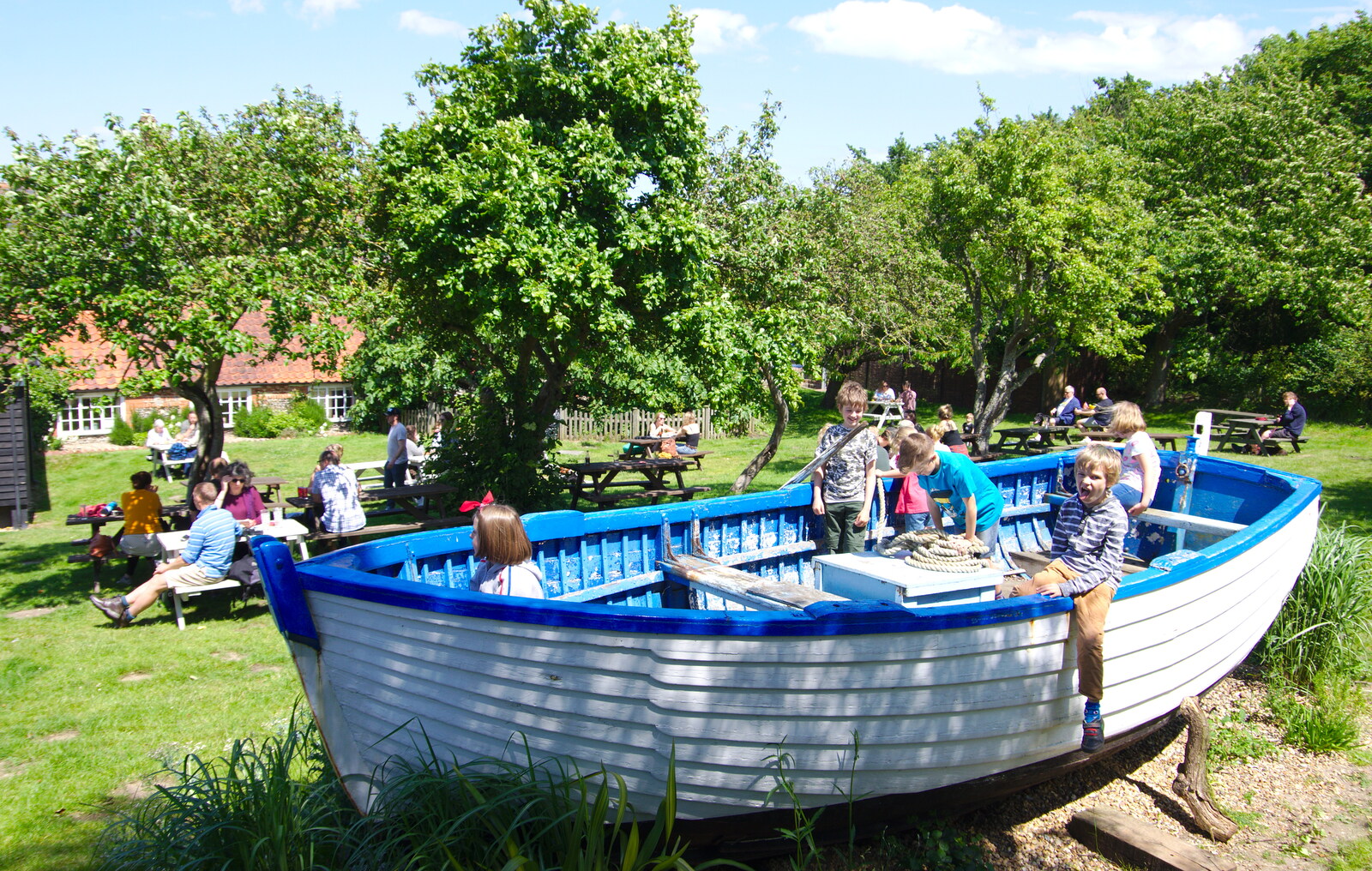 The children pile into a boat in the beer garden from Cliff House Camping, Dunwich, Suffolk - 15th June 2019