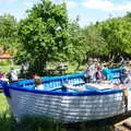 The children pile into a boat in the beer garden, Cliff House Camping, Dunwich, Suffolk - 15th June 2019