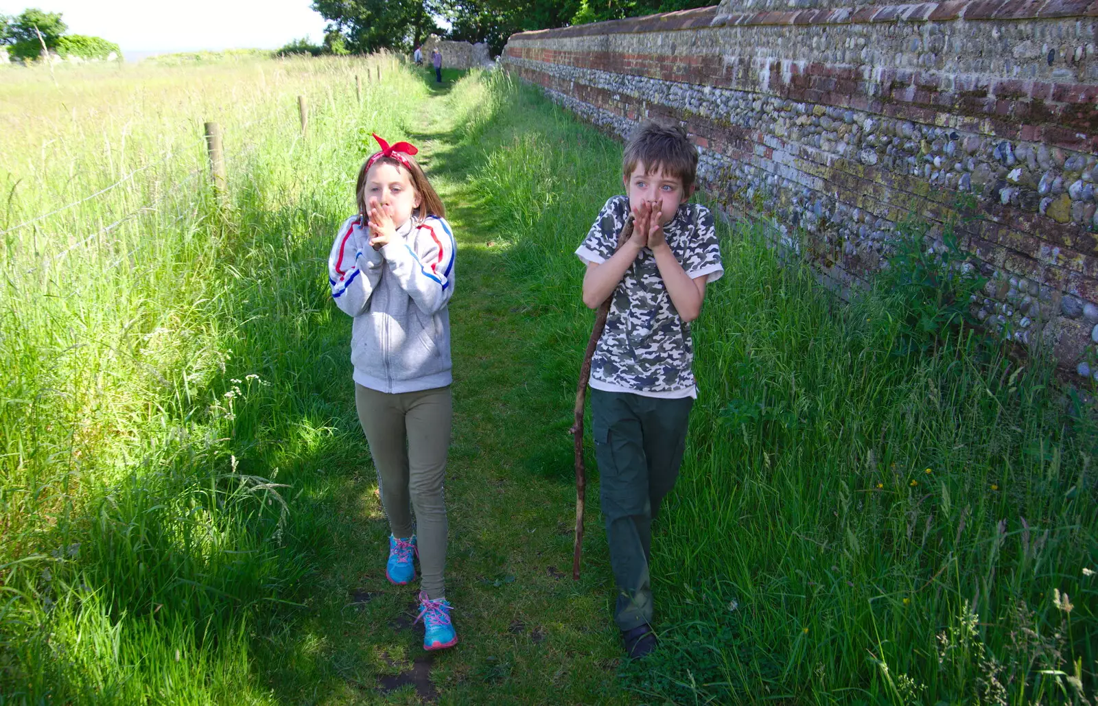 Sophie and Fred learn the grass-blade trumpet thing, from Cliff House Camping, Dunwich, Suffolk - 15th June 2019