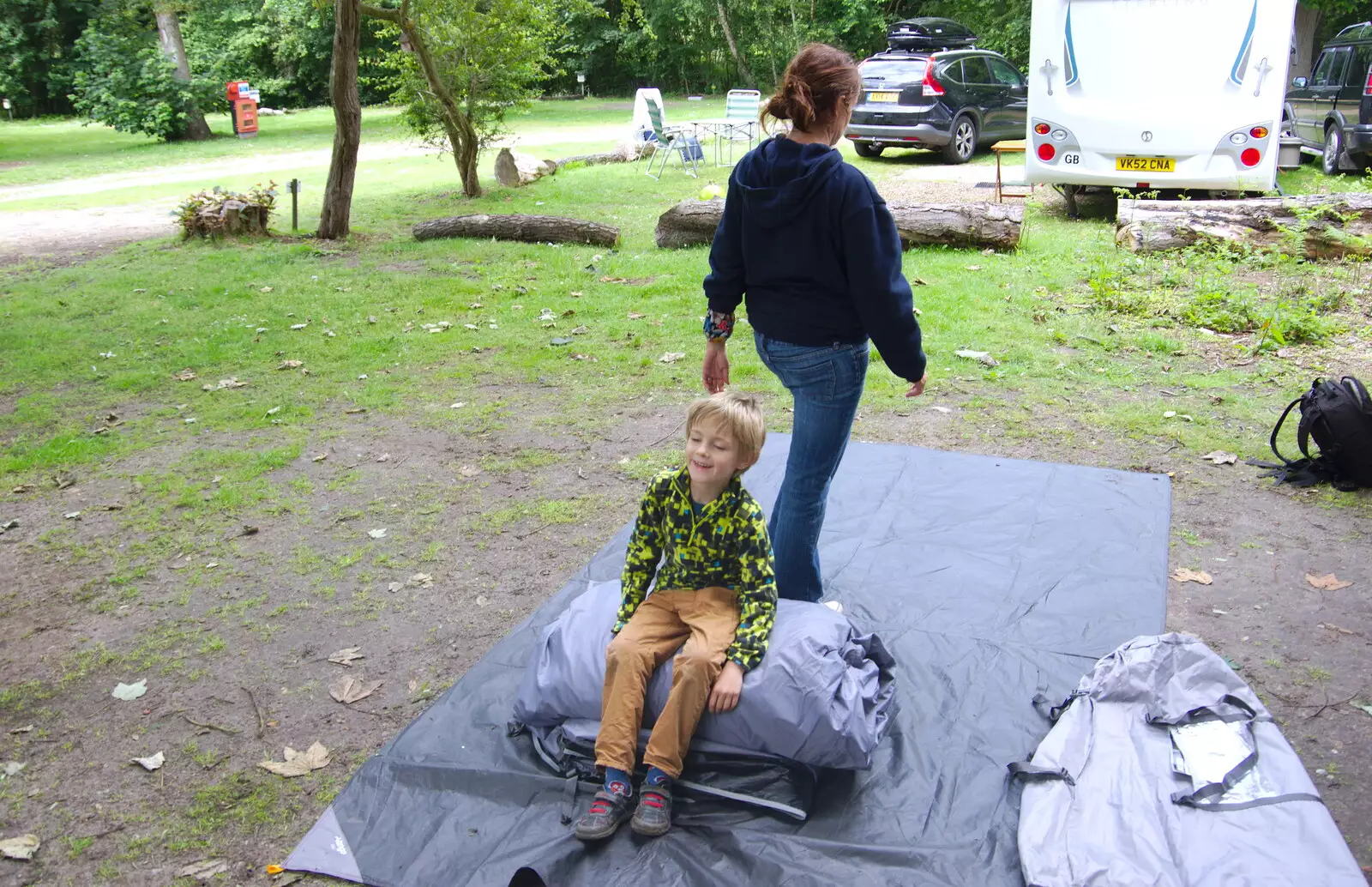 Harry sits on the packed tent, from Cliff House Camping, Dunwich, Suffolk - 15th June 2019