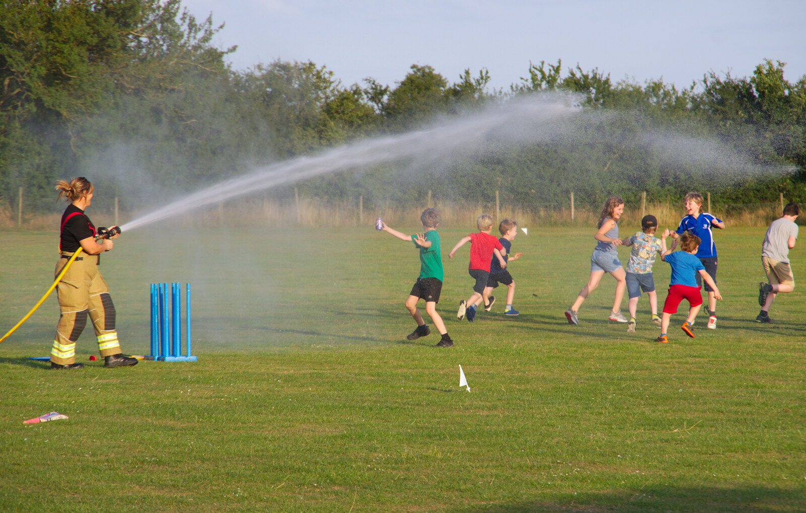 The hose is unleashed from A Water Fight with a Fire Engine, Eye Cricket Club, Suffolk - 5th August 2019