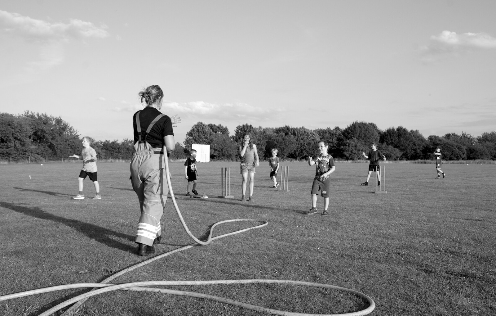 A hose snakes all over the pitch from A Water Fight with a Fire Engine, Eye Cricket Club, Suffolk - 5th August 2019