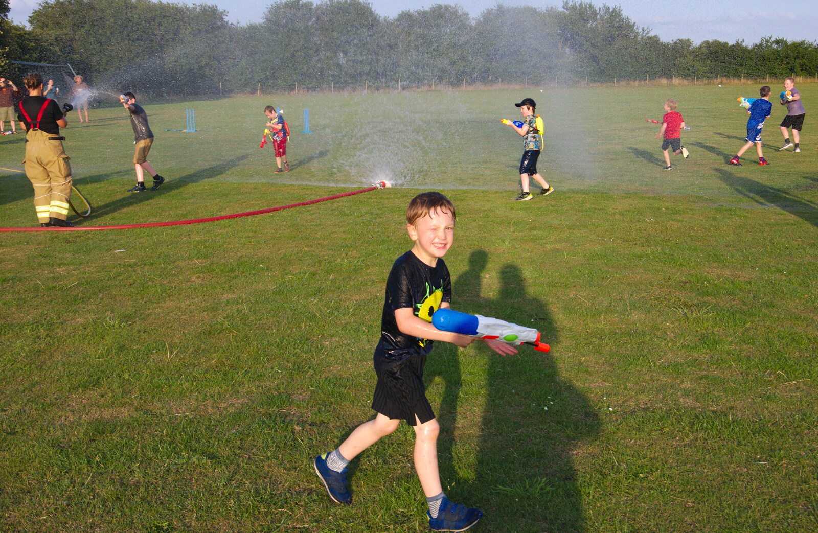 Running around near the spray wall from A Water Fight with a Fire Engine, Eye Cricket Club, Suffolk - 5th August 2019