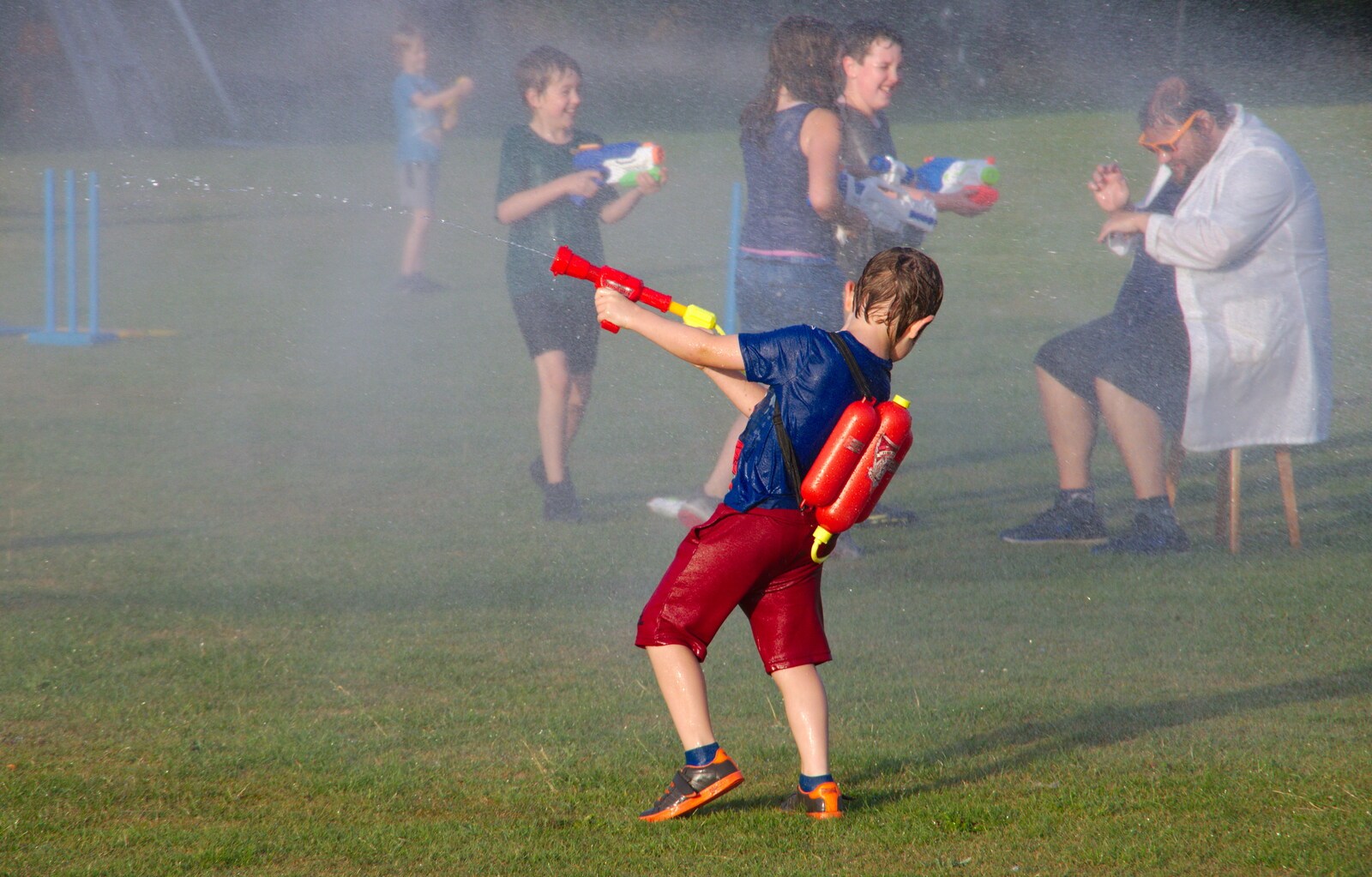 A boy vainly fights back with a small squirter from A Water Fight with a Fire Engine, Eye Cricket Club, Suffolk - 5th August 2019