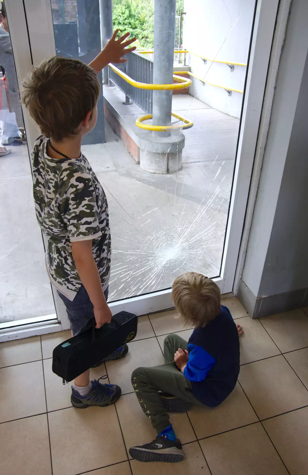 The boys inspect a broken door at the DART station, from Busking in Temple Bar, Dublin, Ireland - 12th August 2019