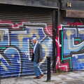 Some dude walks past graffiti shutters, Busking in Temple Bar, Dublin, Ireland - 12th August 2019