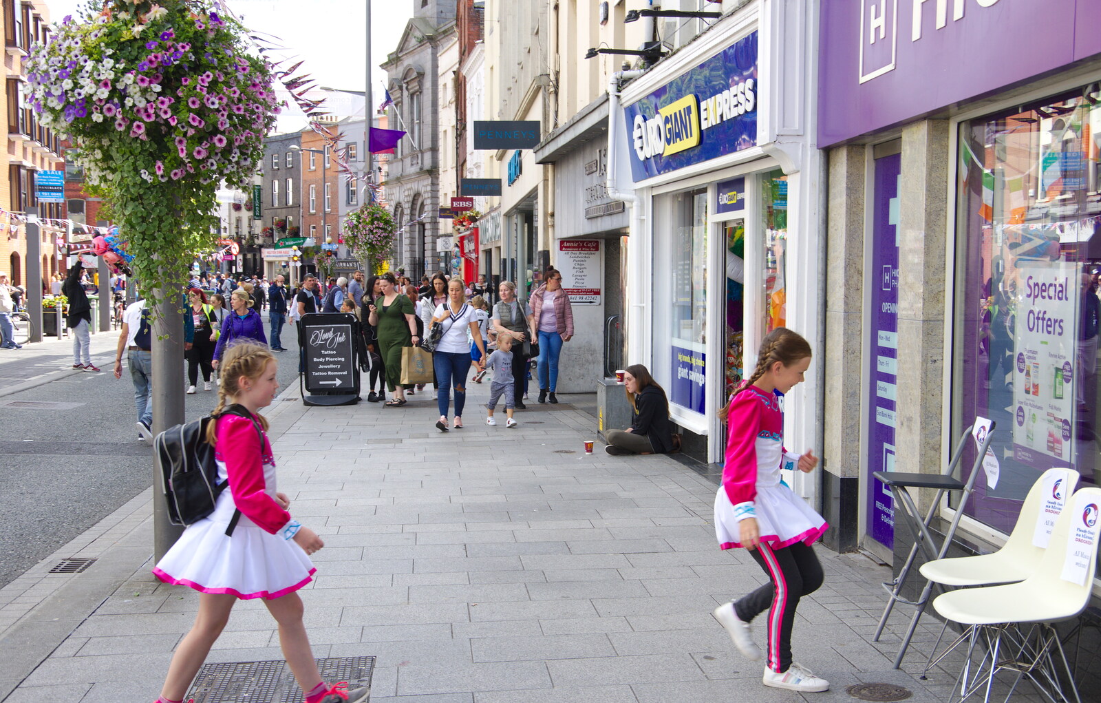 Girls in pink and white skirts claim the seats from The Fleadh Cheoil na hÉireann, Droichead Átha, Co. Louth, Ireland - 13th August 2019