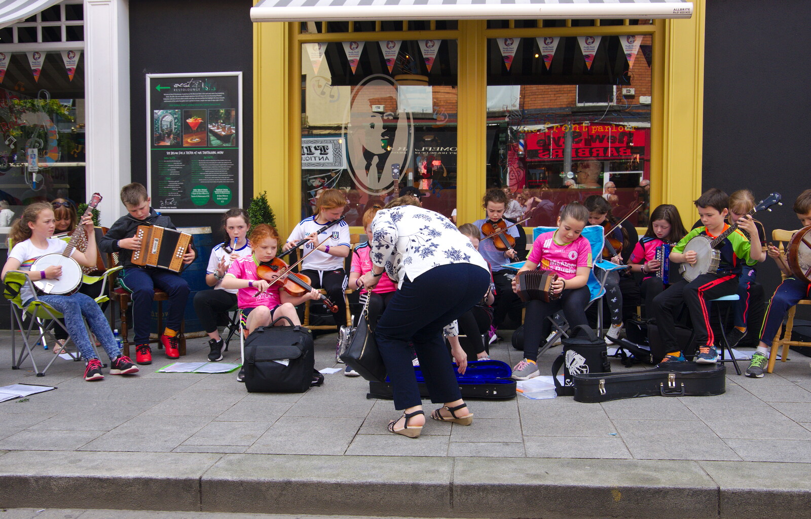 A large trad band is playing just up the street from The Fleadh Cheoil na hÉireann, Droichead Átha, Co. Louth, Ireland - 13th August 2019