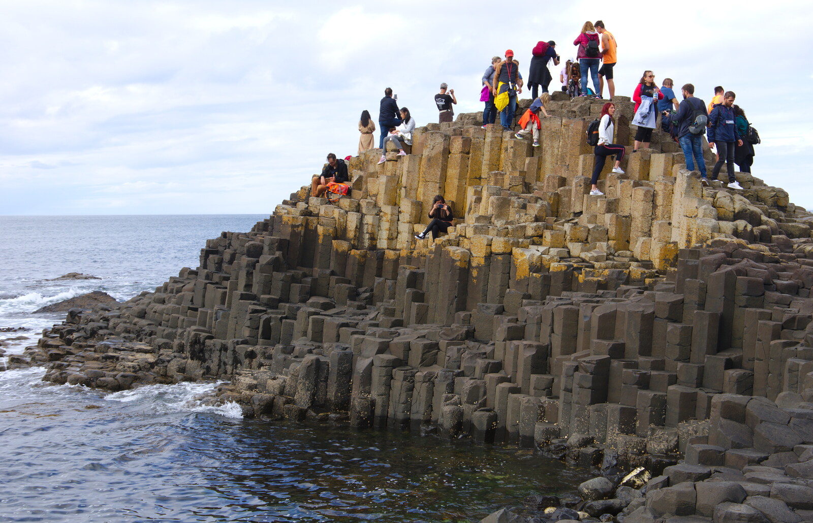 People swarm all over basalt columns from The Giant's Causeway, Bushmills, County Antrim, Northern Ireland - 14th August 2019