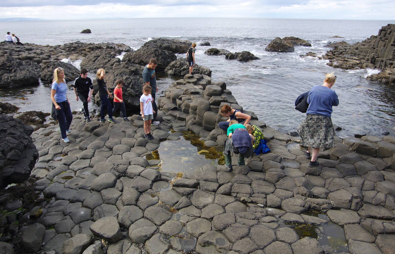 The boys look in a rock pool from The Giant's Causeway, Bushmills, County Antrim, Northern Ireland - 14th August 2019