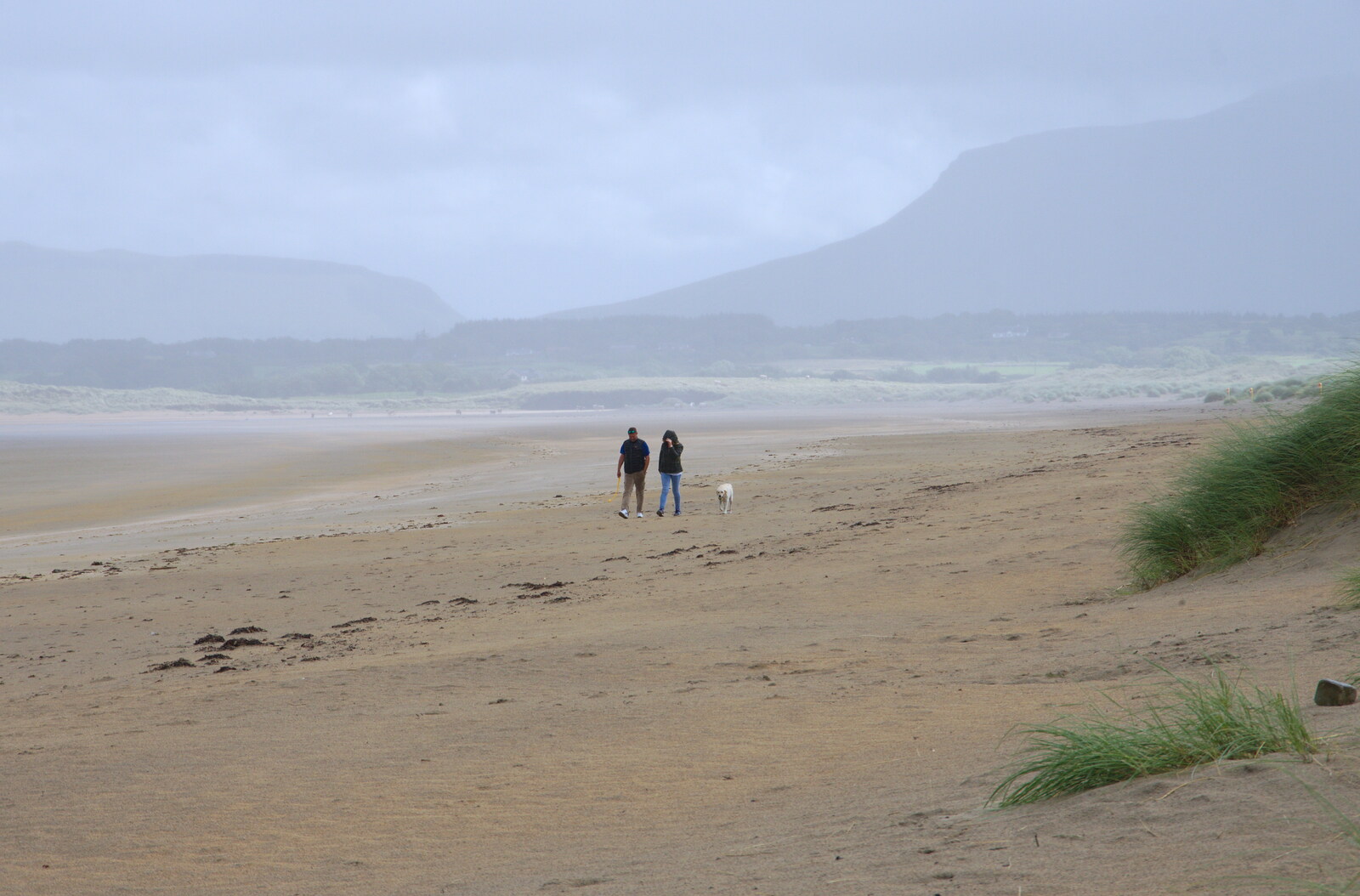 A couple walk around as the weather closes in from Mullaghmore Beach and Marble Arch Caves, Sligo and Fermanagh, Ireland - 19th August 2019