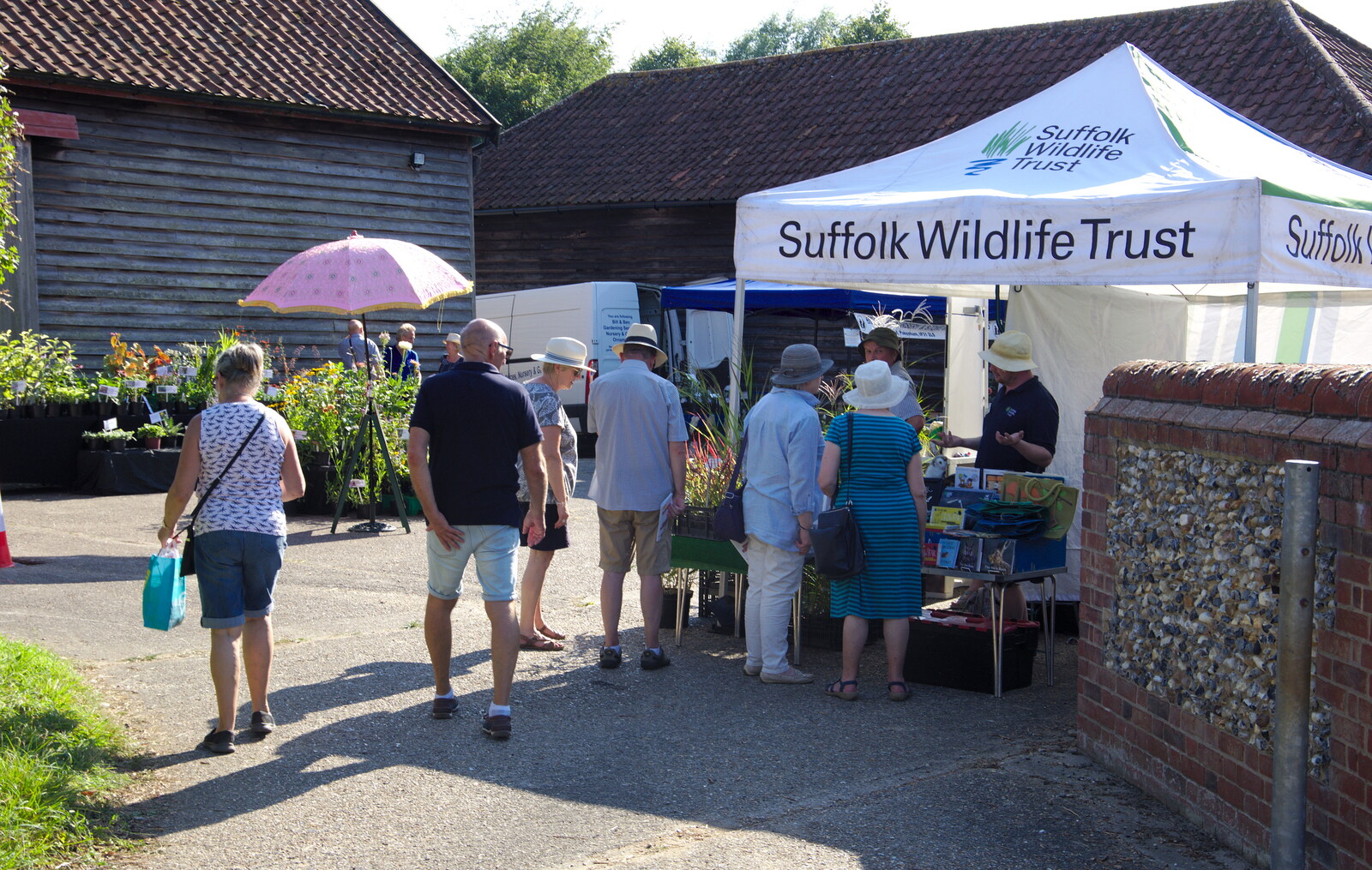 People hang around the Suffolk Wildlife Trust tent from The Gislingham Silver Band at Walsham Le Willows, Suffolk - 26th August 2019