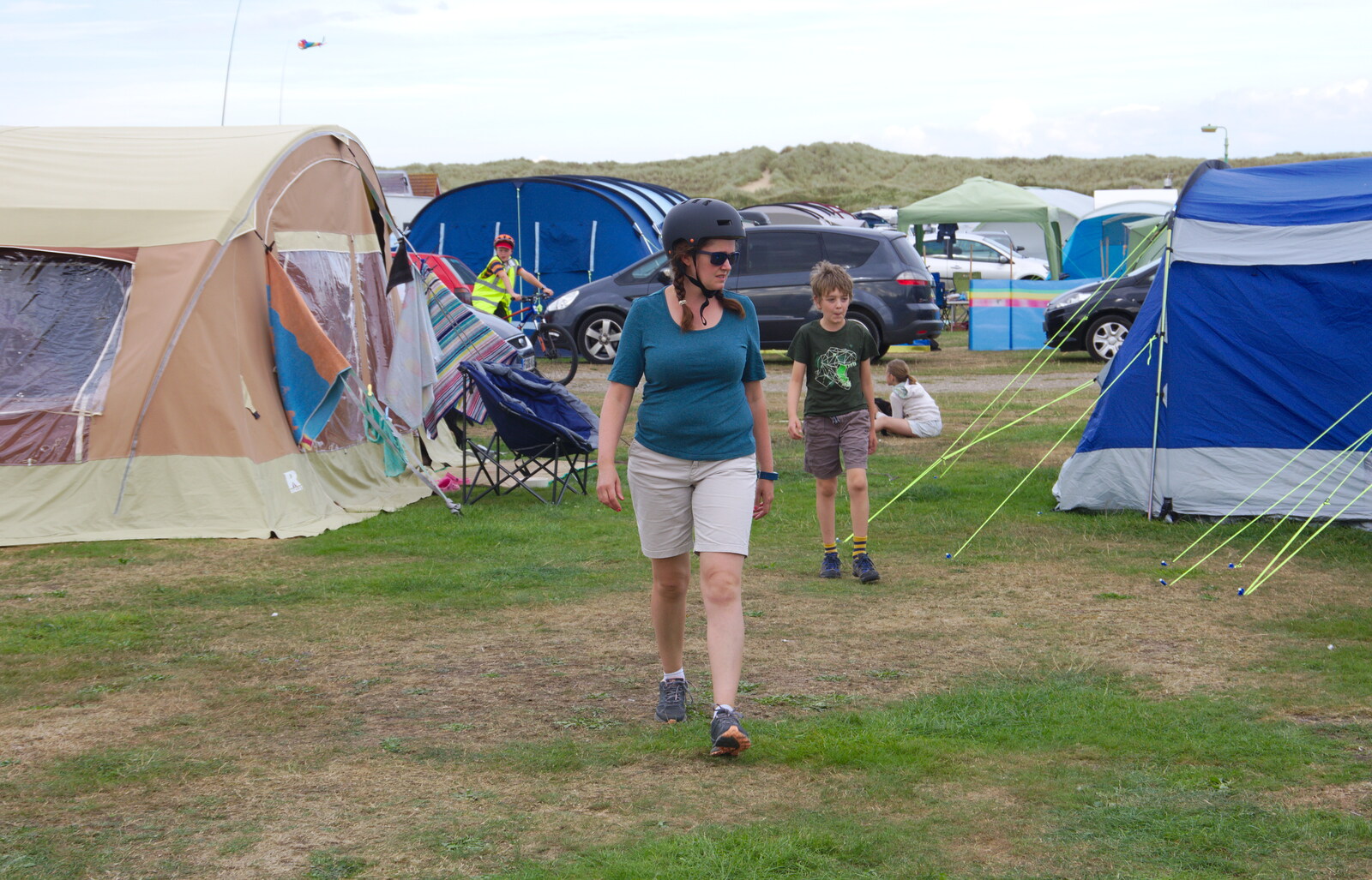 Isobel strides over with bike helmet on from Waxham Sands and the Nelson Head Beer Festival, Horsey, Norfolk - 31st August 2019