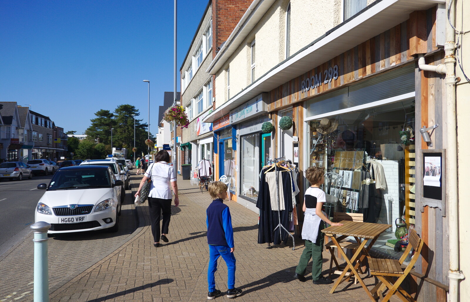Harry looks at shops on Lymington Road from A Trip to the South Coast, Highcliffe, Dorset - 20th September 2019