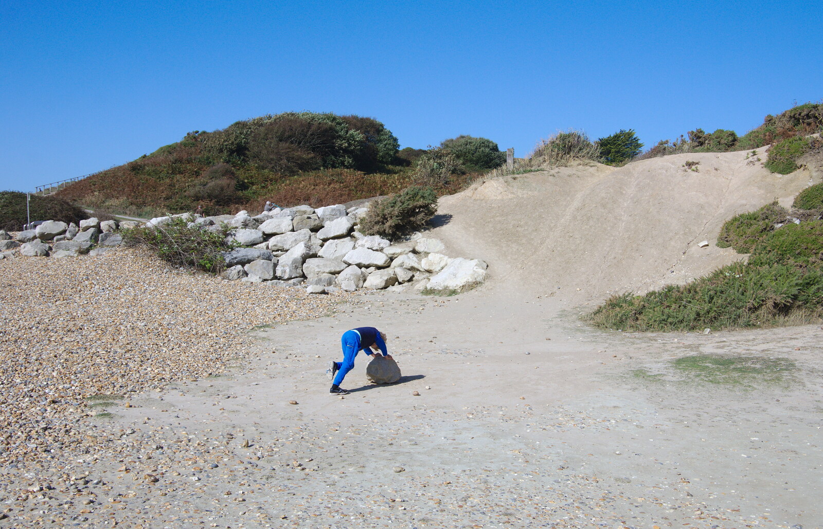 Harry tries to roll a boulder around the beach from A Trip to the South Coast, Highcliffe, Dorset - 20th September 2019