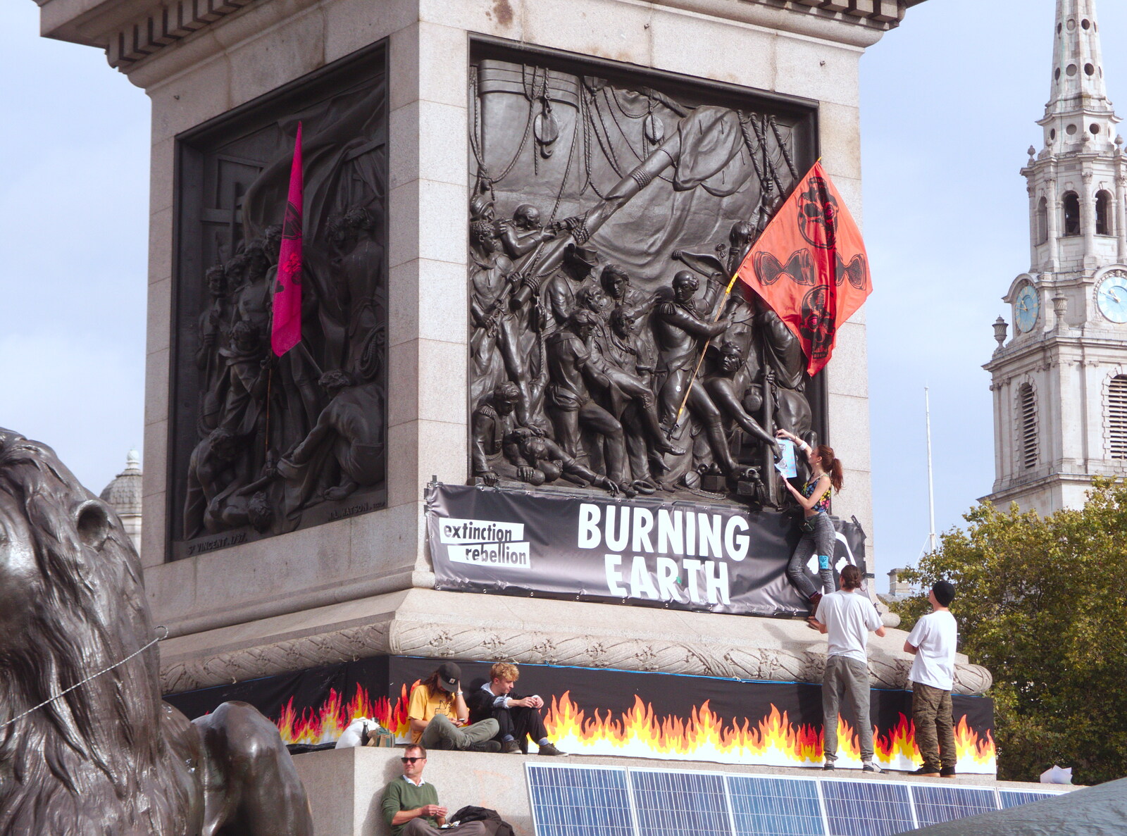 Nelson's Column gets some flags and flyers added from The Extinction Rebellion Protest, Westminster, London - 9th October 2019