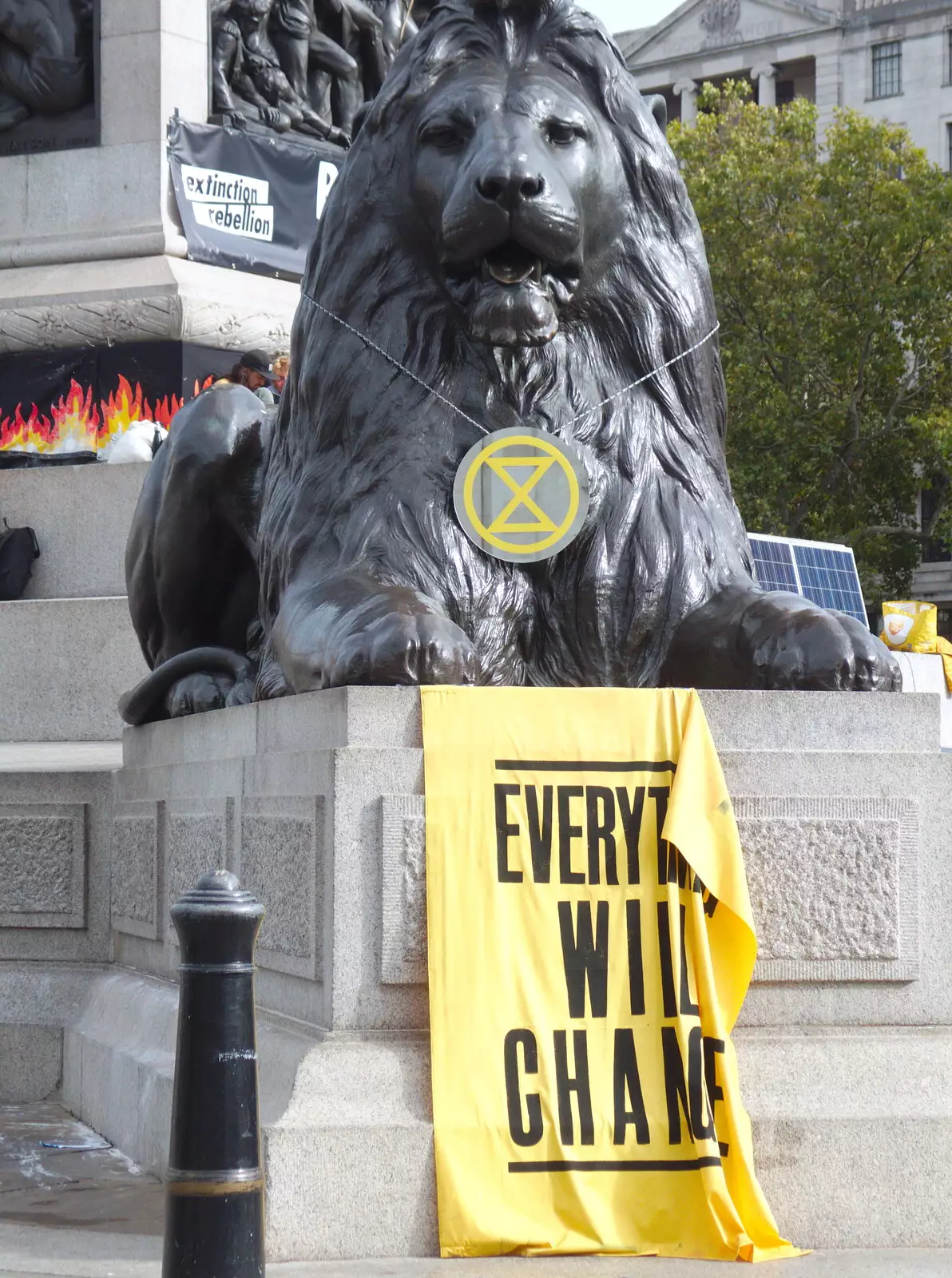 A Trafalgar lion has an XR medallion around its neck, from The Extinction Rebellion Protest, Westminster, London - 9th October 2019